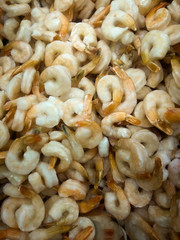 boiled frozen tails of tiger (large) shrimps in a supermarket freezer counter awaiting buyers
