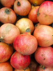 fresh, large and ripe fruits of an Egyptian pomegranate in a supermarket counter