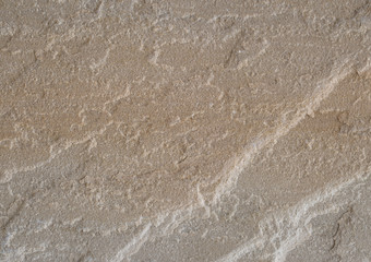 Textur eines braunen Sandsteins mit wellenförmiger Oberfläche