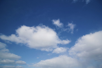 Naklejka na ściany i meble background of white fluffy cumulus clouds