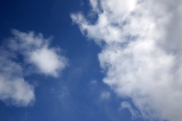 background of white fluffy cumulus clouds