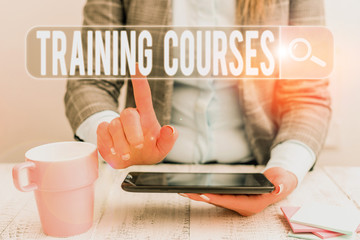 Handwriting text Training Courses. Conceptual photo lessons to teach the skills and knowledge for a job Business woman sitting with mobile phone and cup of coffee on the table