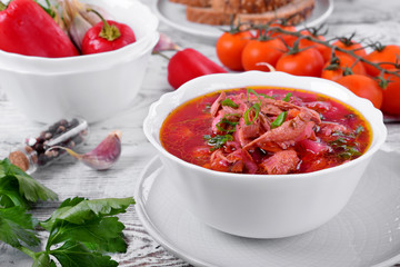Borscht soup with meat in a white bowl. Ukrainian cuisine meal