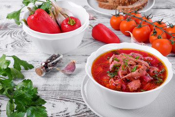 Borscht soup with meat in a white bowl. Ukrainian cuisine meal