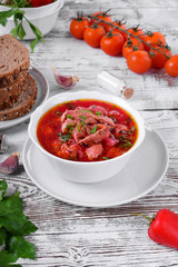 Borscht soup with meat in a white bowl. Ukrainian cuisine meal