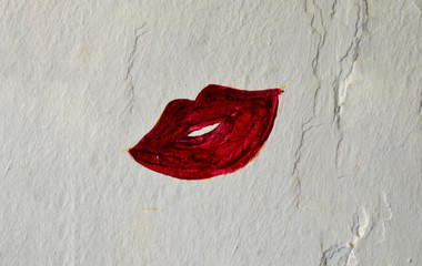 red female lip graffiti on the wall