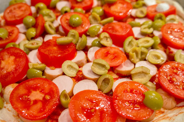 Pizza toppings. Olives tomatoes and mozzarella close-up.