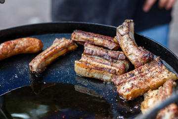 chef cooks ribs at the street food festival