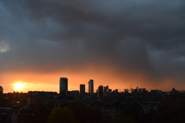 Fototapeta na wymiar Silhouette of Brussels city at sunset under grey clouds