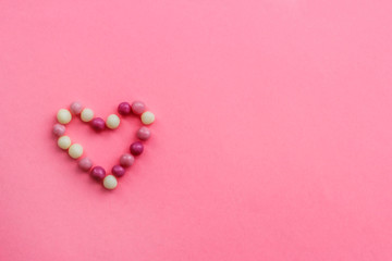 Fototapeta premium heart of round pink and white candy balls. symbol of the heart