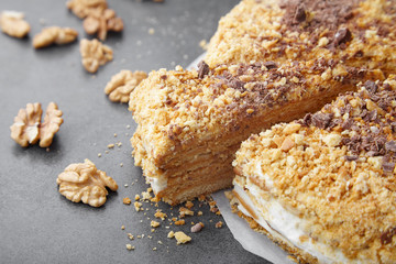 baked pie with cream and nut crumbs, a slice of delicious pastries on a dark background