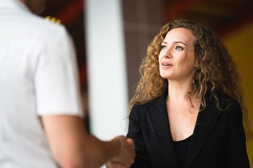 Shot of business woman greeting with the man in front of her in first meet and shake hand in meeting room atmosphere , Concept success business discussion, Selective focus on business woman. © ztony1971