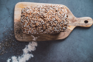 Bio bread with multi seeds on wooden table. Top view.