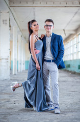 Prom couple. Handsome guy in blue suit and girl in glamorous silver blue dress © stivog
