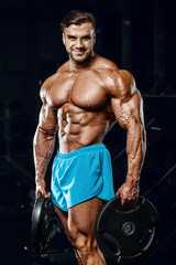 Fototapeta na wymiar good looking fitness man pumping up muscles