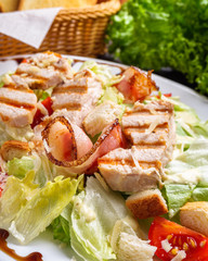 Caesar salad on dark wooden rustic background