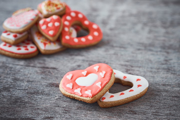 Two heart shape cookies and many decorated cookies on the gray background. Valentines Day concept