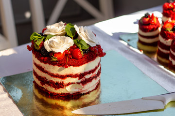 Red velvet cake with close up with white roses and knife