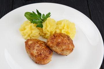 Chicken meat cutlet with mashed potatoes on white plate