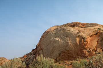 Low angle landscape of large yellow and white rock formations at Dinosaur National Monument in Utah