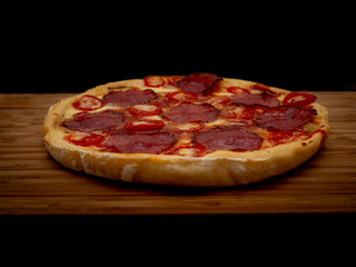 Pizza with salami and cheese. Top view. Free copy space.