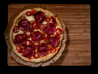 Pizza with salami and cheese. Top view. Free copy space.