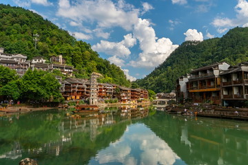 Sunset view on riverside Tuojiang River with Wanmingta Pagoda. Picturesque landscape of traditional chinese old town of Fenghuang, Hunan province, China