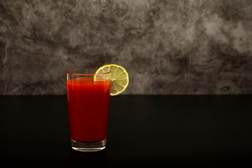 Bloody Mary Cocktail Bar with a variety of side dishes. Bloody Mary tomato juice with vodka olives lemon and pepper on a gray background.