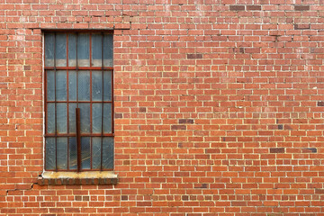 red brick wall rusted old window bars