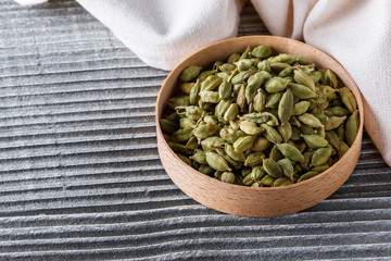 fragrant green cardamom on a wooden rustic background