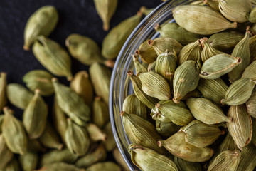 fragrant green cardamom on a dark stone background