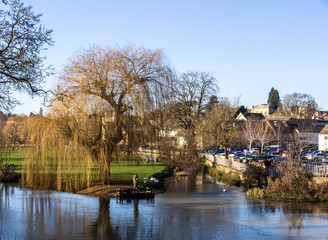 Fototapeta na wymiar Fisherman on the river welland in the beauitiful lincolnshire town of stamford landscape.
