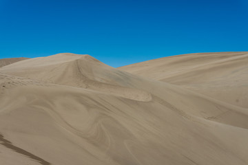 Fototapeta na wymiar Giant sand dune landscape with clear blue sky