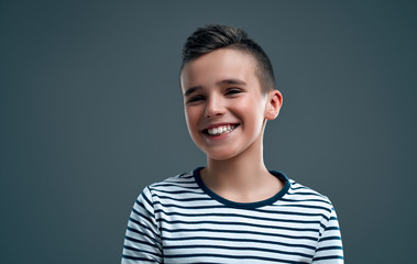 Fashionable boy on a gray background