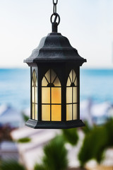 Vintage lamp on a background of the sea