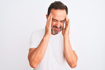 Middle age handsome man wearing casual t-shirt standing over isolated white background with hand on head for pain in head because stress. Suffering migraine.