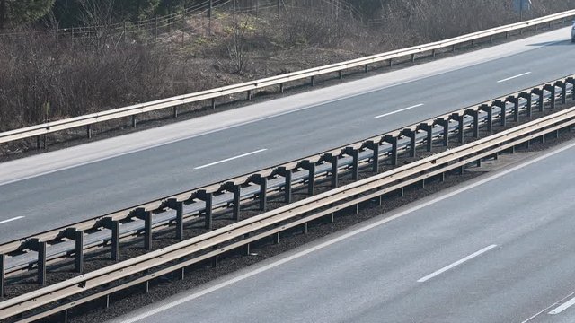 LD Median barrier on the highway and traffic on the road