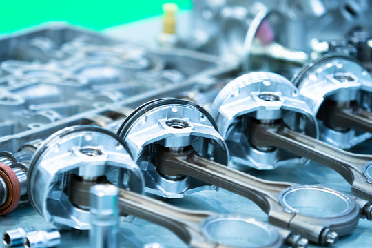 The pistons of the engine closeup. Disassembled motor on the table in the workshop. Car repair. Production of engines for cars. Maintenance of motors. Automotive concept.