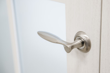 Metal doors knob handle on modern interior