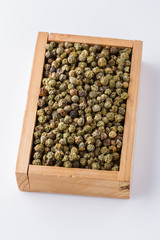 green peppers in wooden box on white background