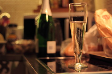 Champange glasson a kitchen counter during a party.