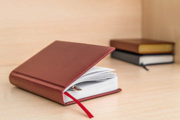 diary, Office Desk. Book layout blank leather case for magazine, booklet, brochure, diary, business portfolio layout design Template on a wooden background. business concept, diary and fountain pen