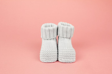 Knitted booties for newborn baby girl. Footwear for infant.