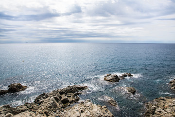 Much stones in water in the sea in Spain.