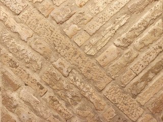 Masonry on the floor of marble brick in warm tones. Texture and background for design and decoration. Natural building material. The work of a mason. Ancient solid buildings. historical technologies o