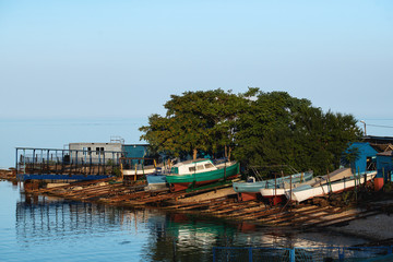 Fototapeta na wymiar An old wooden fishing boat covered in graffiti on dry dock.
