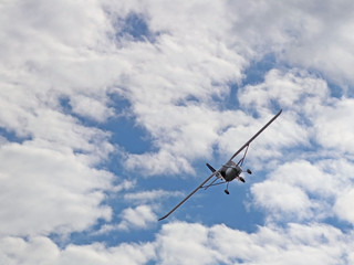 Yaslo, Poland - july 1 2018: A light sport turboprop aircraft flies across the sky among the rainy clouds. Landing in difficult weather conditions. Meteorology and weather forecast for aviation