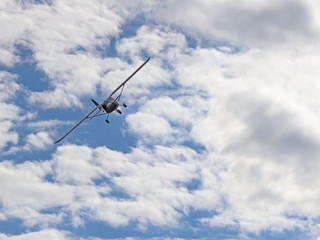 Yaslo, Poland - july 1 2018: A light sport turboprop aircraft flies across the sky among the rainy clouds. Landing in difficult weather conditions. Meteorology and weather forecast for aviation
