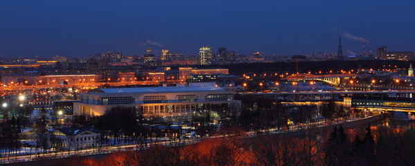 Naklejka premium City buildings, Moscow river and 3rd Transport Ring bridge at winter night, panoramic view from Vorobyovy Gory Observation deck, Russia