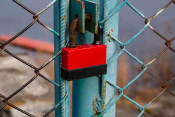 Powerful lock on the fence. Closed doors.